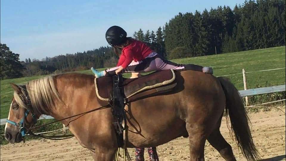 Spagat auf Pferd